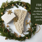 Maeven Box holiday promotion with Mrs. and Mr. knit Christmas stockings and holiday wreath and gold ornaments