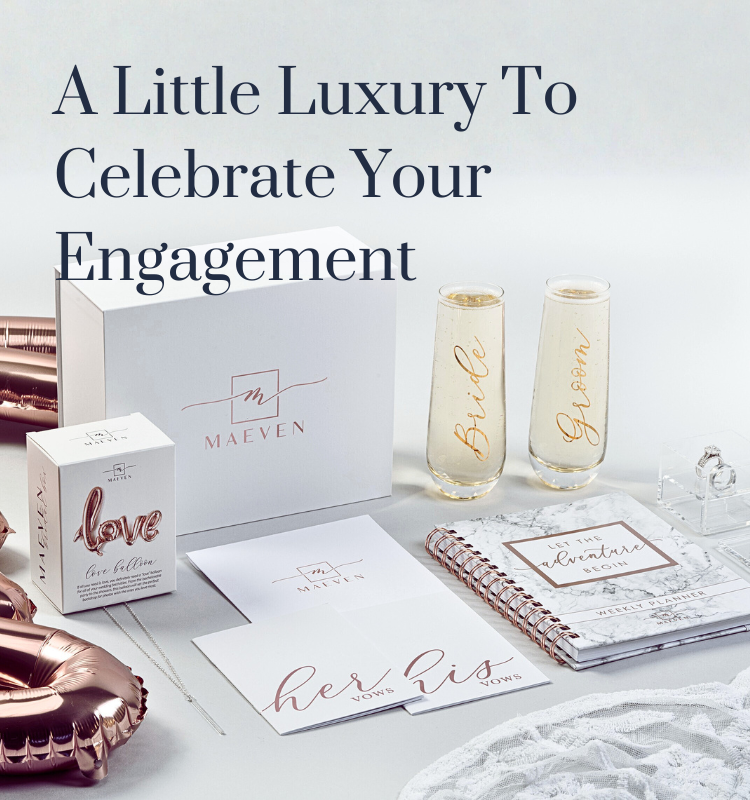 engagement gift box with wedding planner, bride and groom champagne flutes, and his and hers vow books