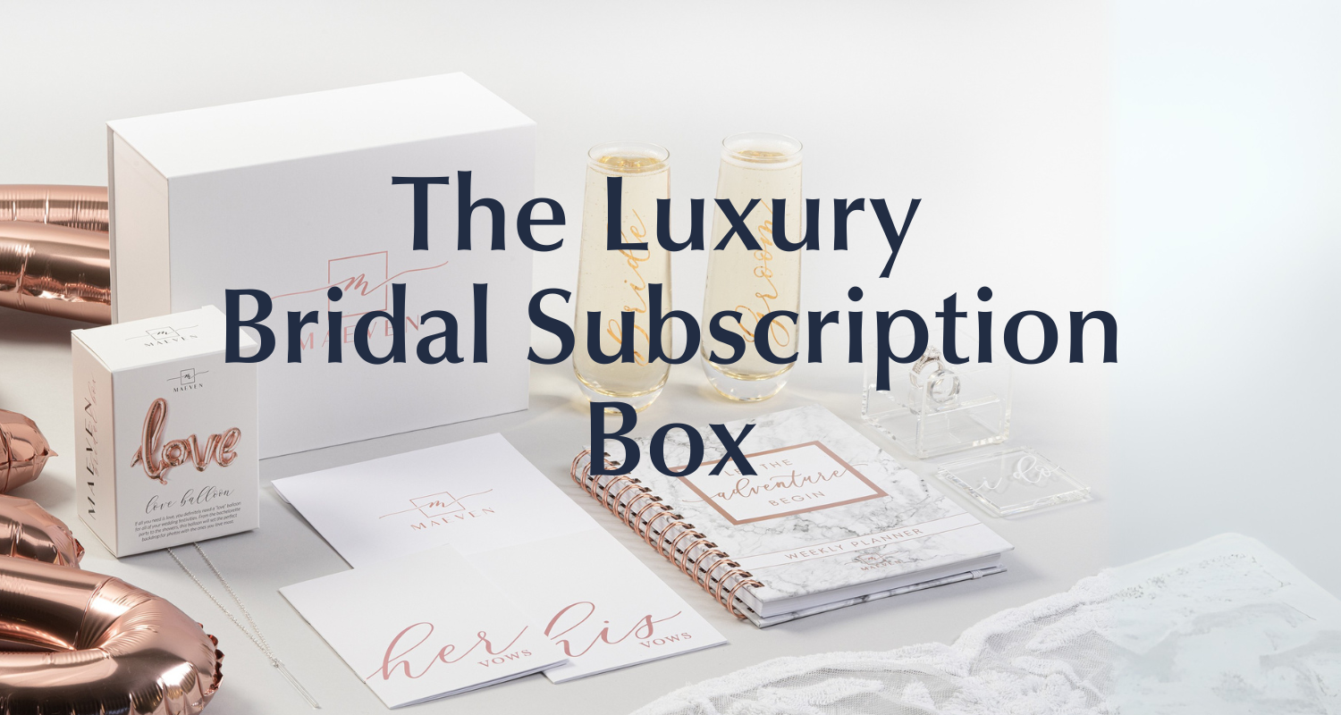 luxury bridal subscription box with bride and groom champagne flutes, wedding planner, vow books, ring box, and love balloon