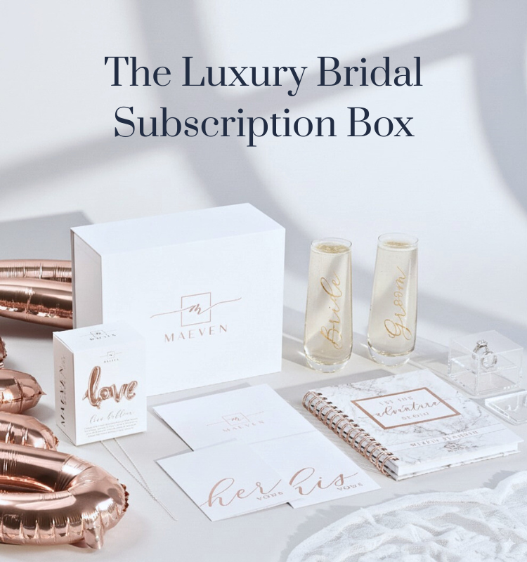 Luxury bridal subscription box with champagne flutes, jewelry, and other wedding planning essentials