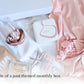 Spa gift box for the bride to be containing a pink satin robe, pave bracelet, mrs wine glass, mrs travel jewelry box, face masks, undereye mask